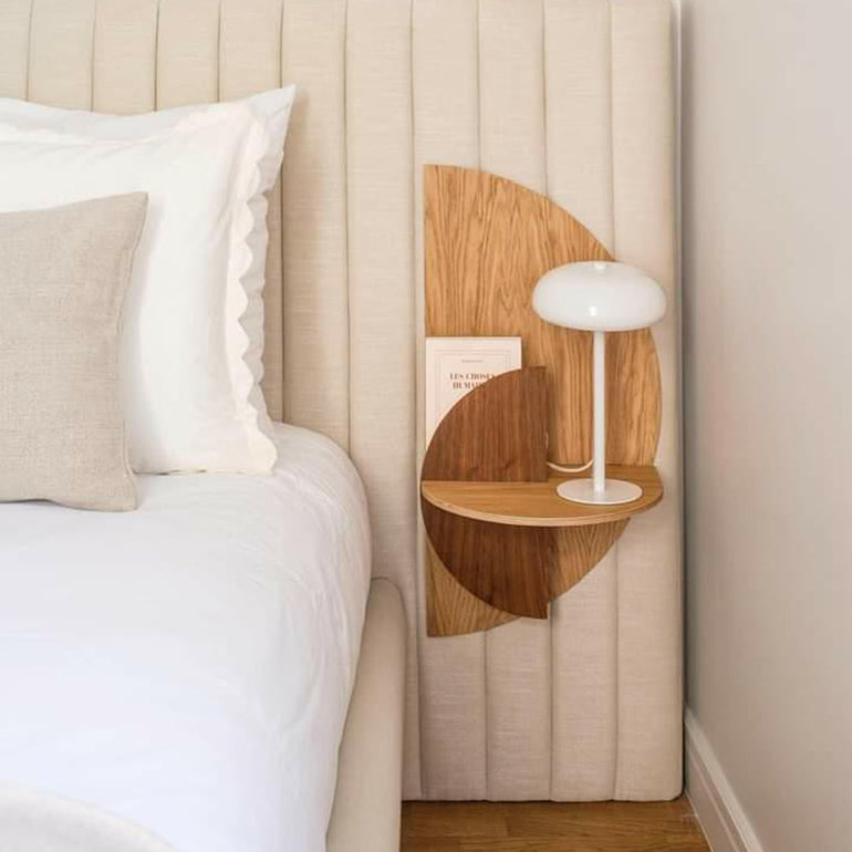 Oak Alba Slim floating bedside table with a walnut Moon front panel beside a bed.