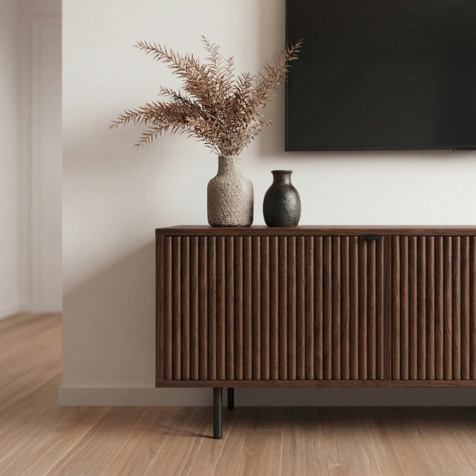 Detail of the walnut-toned textured doors and black leg on a Pau TV unit