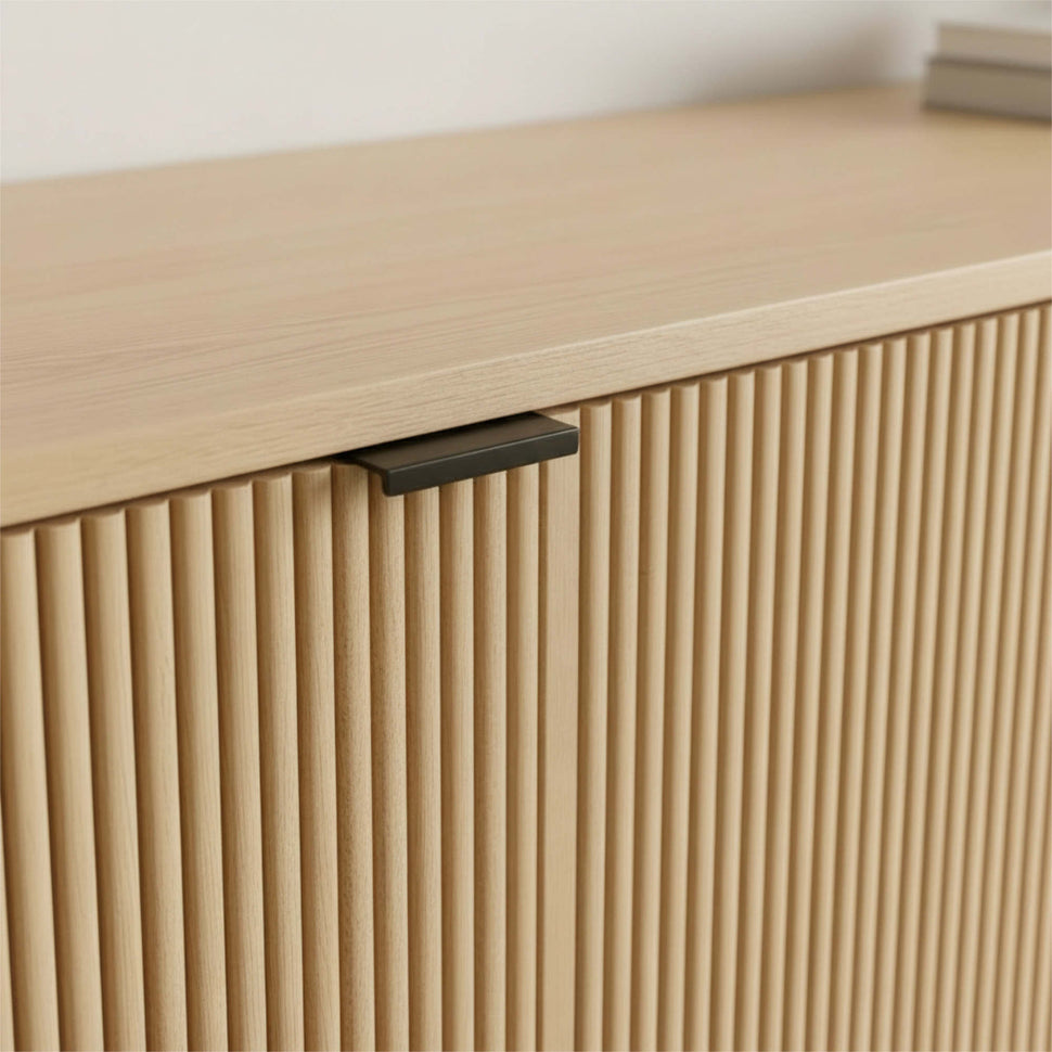 Black handle above an oak-toned textured Pau door