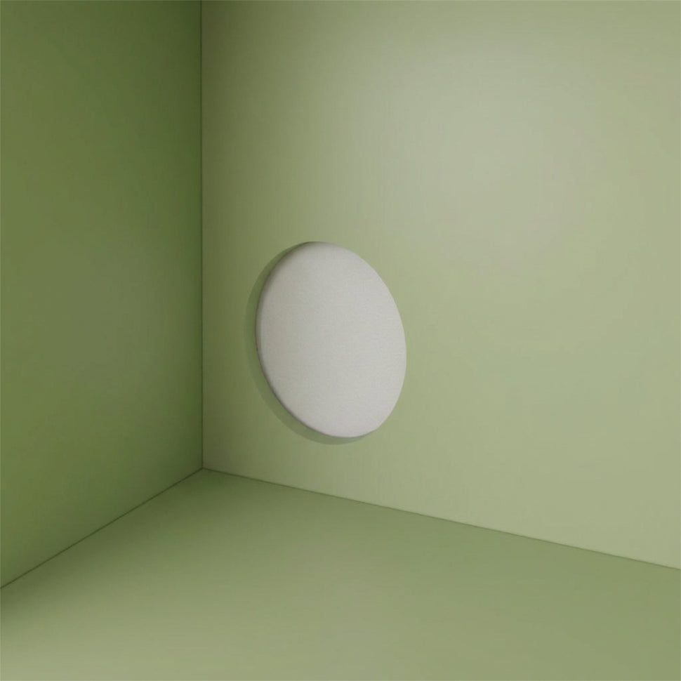 Round cable opening in the pale green interior of a Pau TV unit