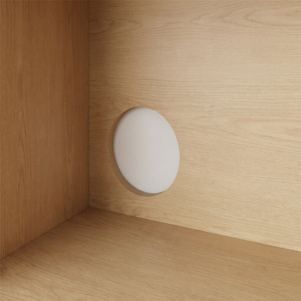 Round cable opening inside an oak-toned Pau TV unit
