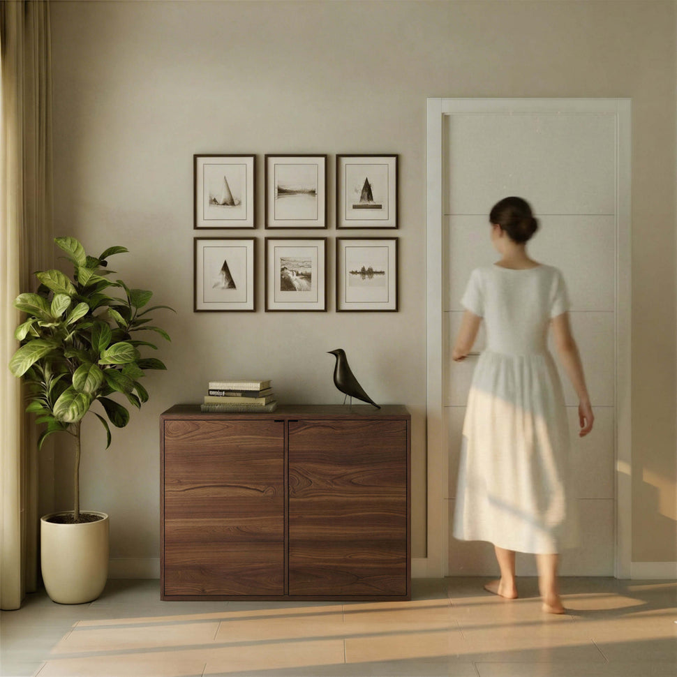 Person beside a two-door walnut-toned Pau sideboard with smooth fronts