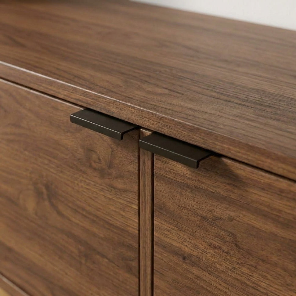 Black handles at the top of smooth walnut-toned Pau doors
