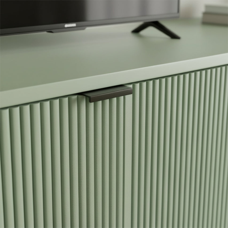 Black handle and textured pale green door on a Pau TV unit