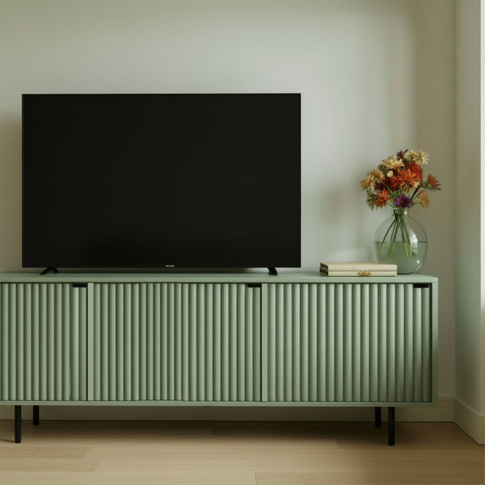 Pale green Pau TV unit with textured doors, shown from the front beneath a television