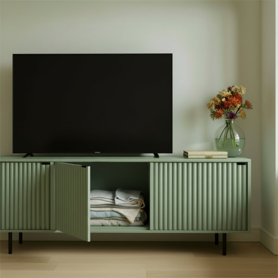Pale green Pau TV unit with a central door open and folded textiles inside