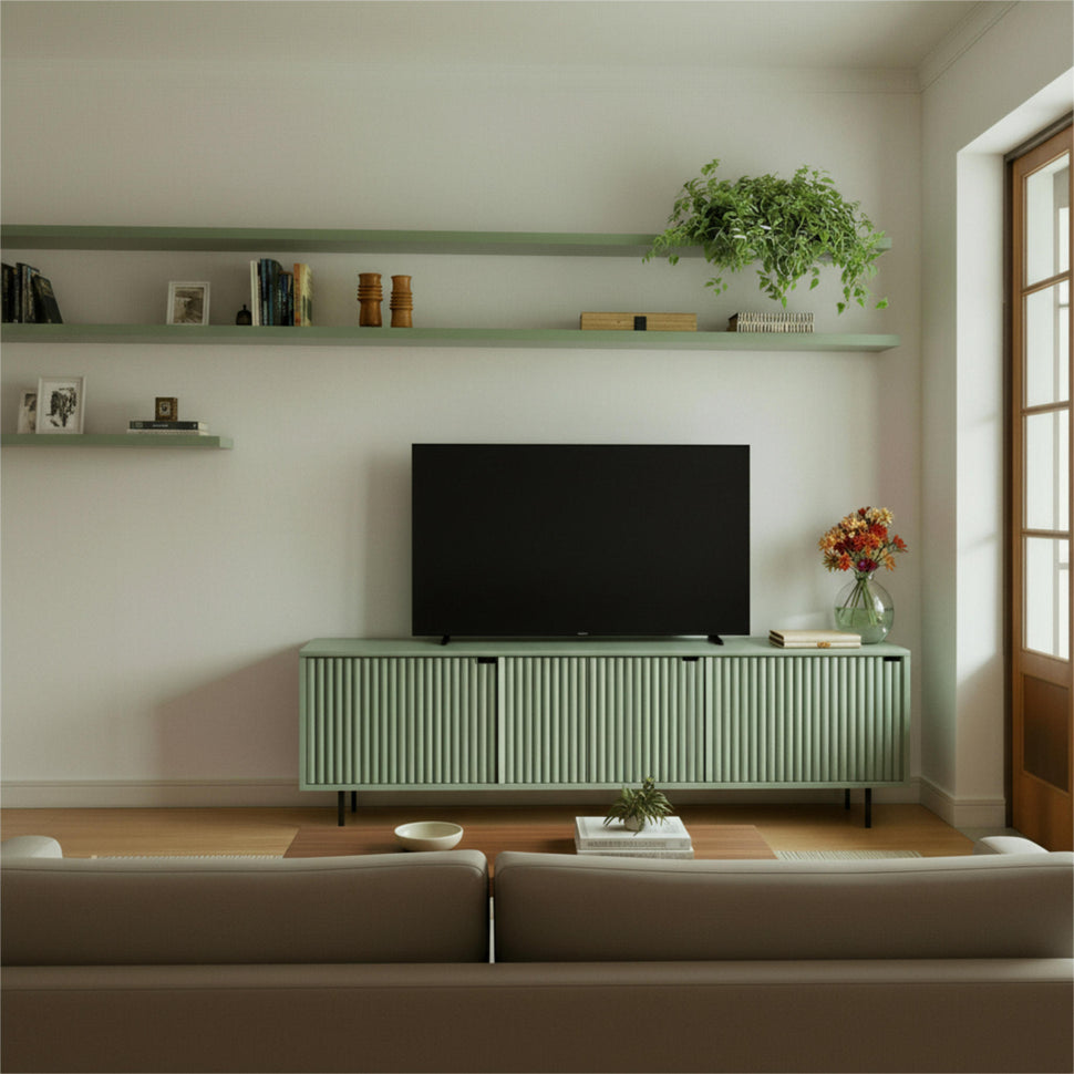 Pale green Pau TV unit with textured doors beneath a television in a living room