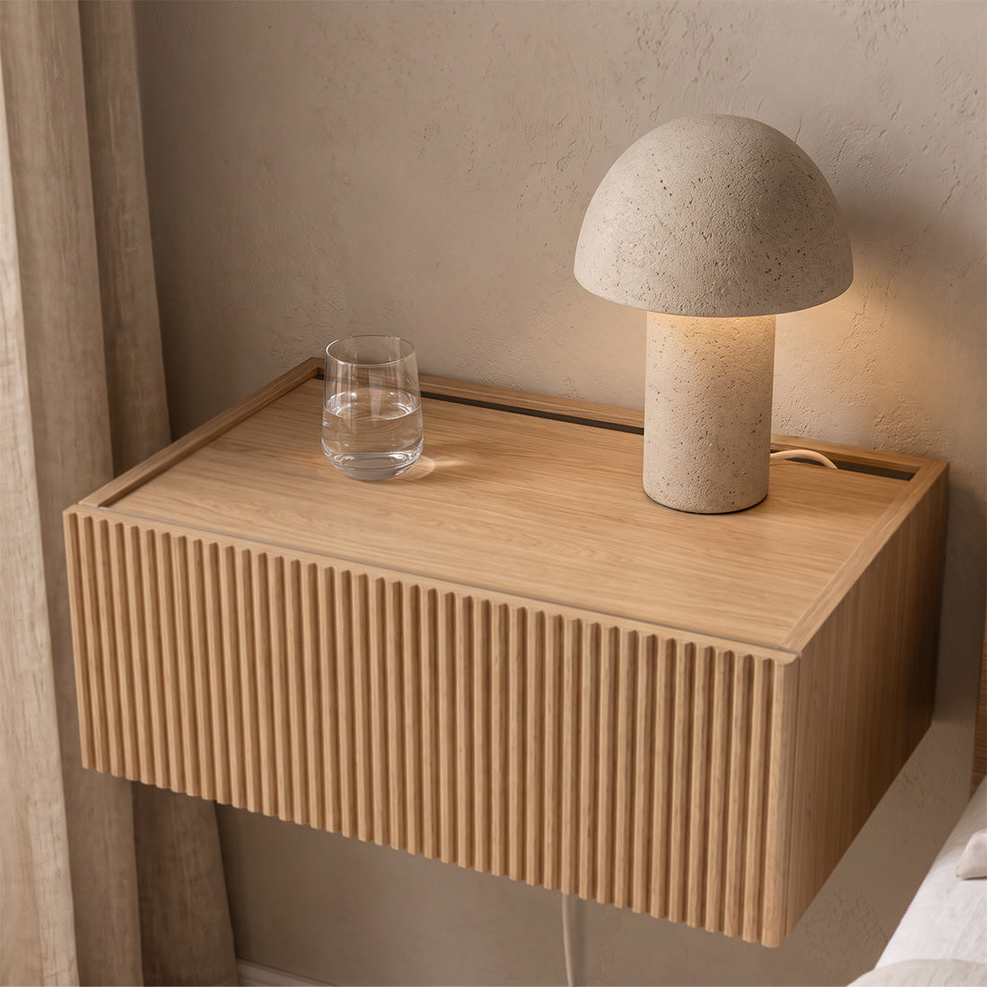 Close-up of a Dalea oak floating bedside table with grooved drawer and rear cable slot