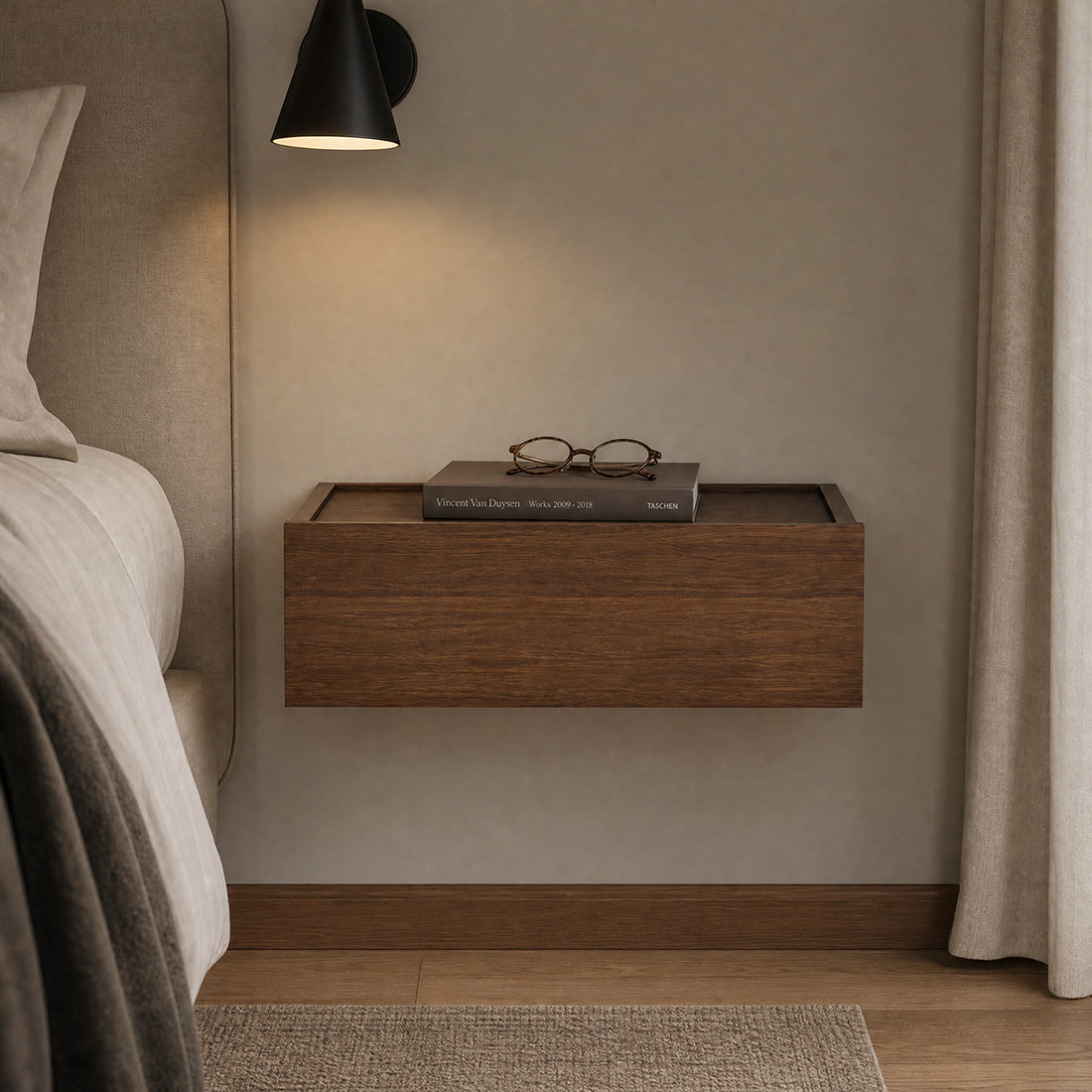 Dalea floating bedside table in natural walnut with a smooth drawer front beside a bed